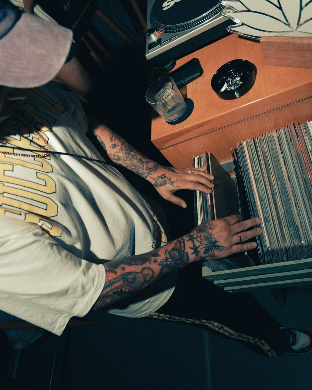 Banx flipping through a crate of records